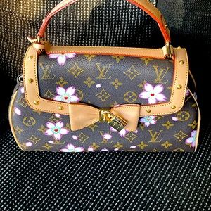 LV vintage bag with gold embellishments.  Knockoff.